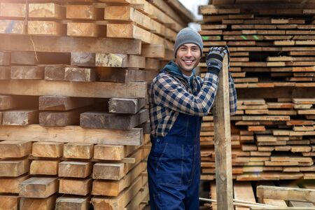 Young male worker in timber warehouseの写真素材