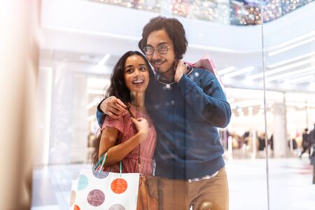 Happy young couple in shopping mallの写真素材
