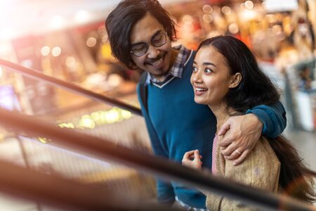 Happy young couple in shopping mallの写真素材
