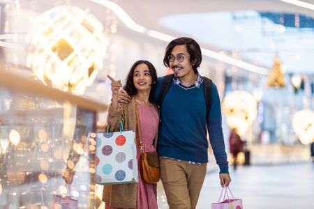 Happy young couple in shopping mallの写真素材