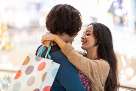 Happy young couple in shopping mallの写真素材