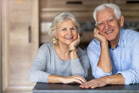 Happy senior couple in their homeの写真素材