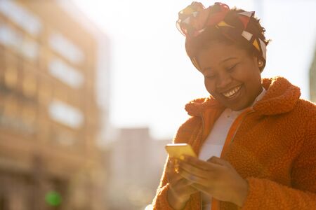 Young woman with smartphone in an urban city areaの写真素材
