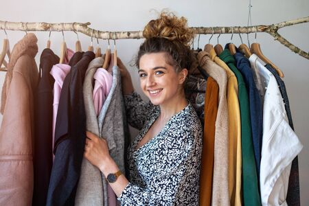 Young woman choosing clothesの写真素材