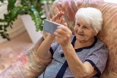 Elderly woman using smartphoneの写真素材