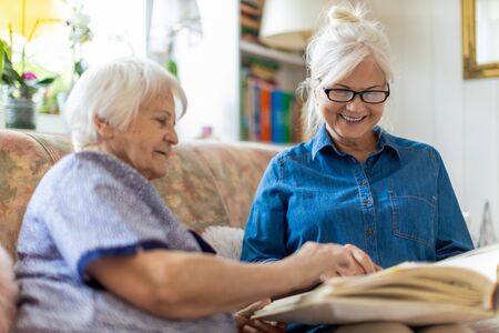 Granny showing her daughter memories from pastの写真素材