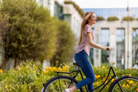 Attractive young womanÂ going for a bicycle rideの写真素材