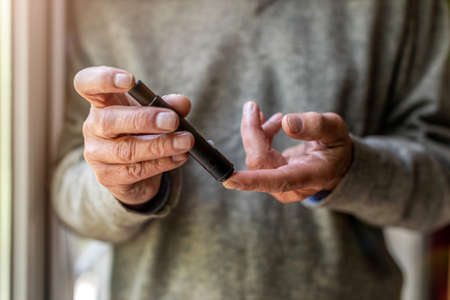 Senior man checking blood sugar levelの写真素材
