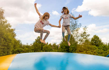 Happy children jumping on inflatable bouncerの写真素材