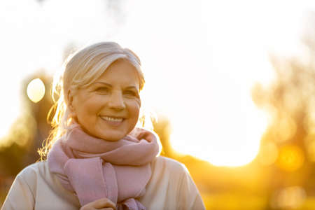 Senior woman enjoying autumn colors