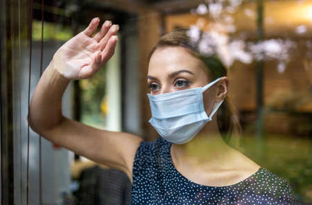 Woman wearing protective face mask in the office for safety and protection during COVID-19の写真素材