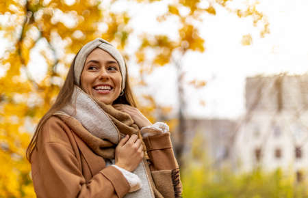 Portrait of smiling young woman in a park in autumnの写真素材
