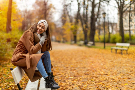 Portrait of smiling young woman in a park in autumnの写真素材