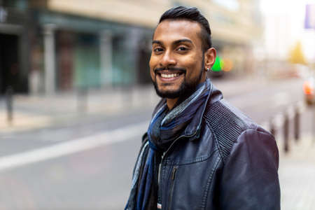 Portrait of a handsome young man on the city street