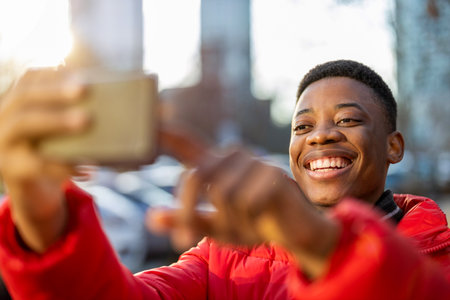 Young man using smart phone outdoors at urban setting