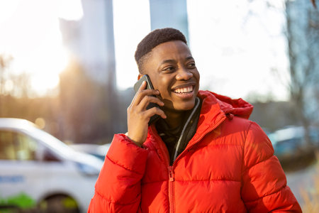 Young man using smart phone outdoors at urban setting