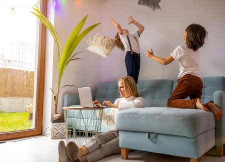 Mother trying to work from home with her kids as a company