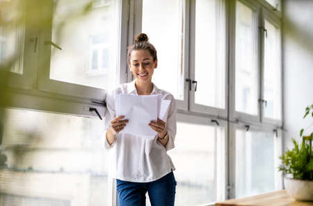 Young female freelancer working in loft office