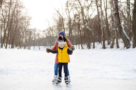 Mother and son ice skatingの写真素材