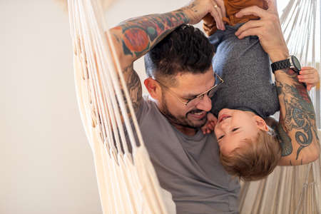 Father and baby son having fun together at homeの写真素材