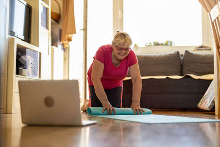 Senior woman exercising at homeの写真素材