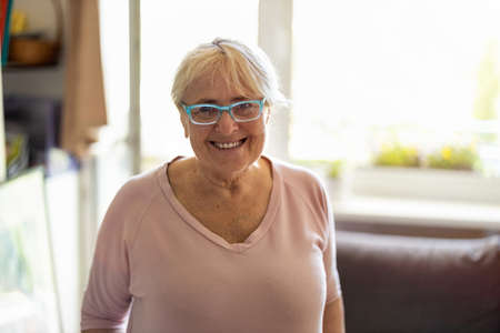 Happy senior woman smiling at homeの写真素材