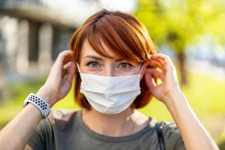 Young woman wearing protective face mask outdoors