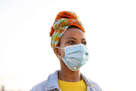 Young woman wearing protective face mask outdoors