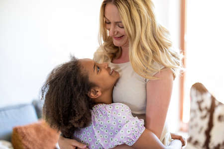 Mother and daughter hugging at home