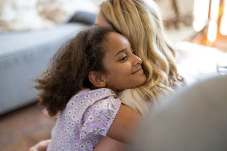 Mother and daughter hugging at home