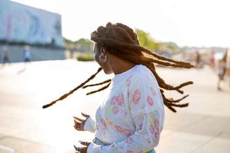 Beautiful young woman enjoying the outdoors at sunsetの写真素材