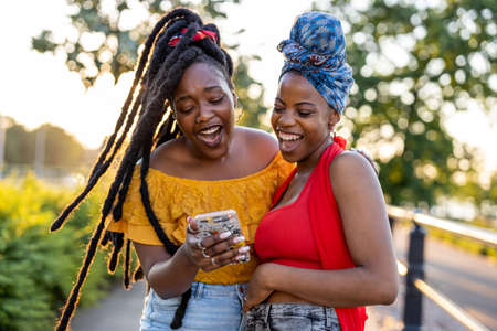 Two girlfriends having fun outdoorsの写真素材