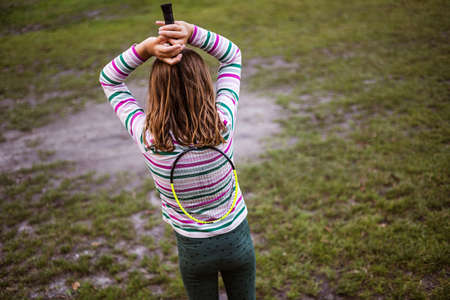 Girl with badminton racket, rear viewの写真素材