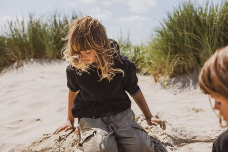 Two sisters playing on the beachの写真素材