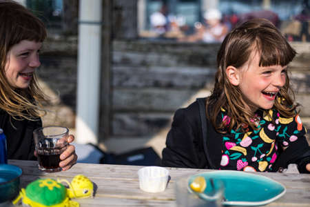 Children having fun in a beach cafeの写真素材