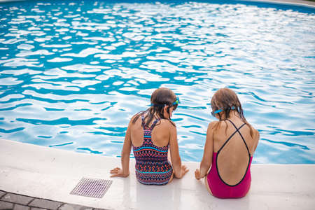 Children playing in the outdoor poolの写真素材