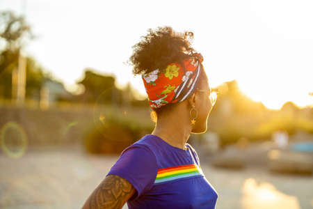 Woman wearing T-shirt with rainbow flag outdoorsの写真素材