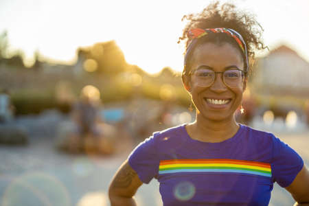 Woman wearing T-shirt with rainbow flag outdoorsの写真素材