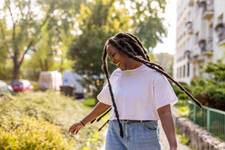 Young Woman Dancing and Tossing Hair Outdoors
