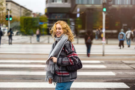 Young woman on a crosswalk in Warsaw, Polandの写真素材