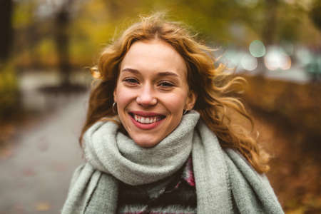 Happy young woman in autumn park