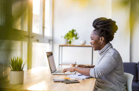 Woman working on laptop in her officeの写真素材