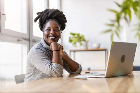 Woman working on laptop in her office