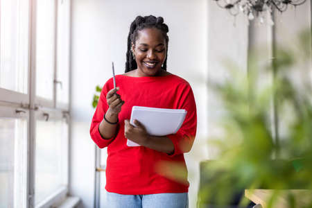 Young woman looking at paperwork in an office