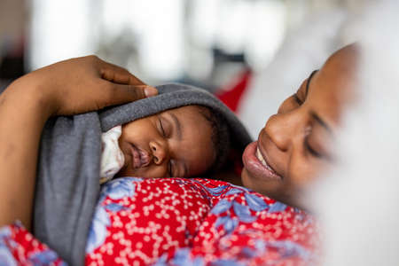 Mother with her newborn baby at homeの写真素材