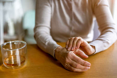 Senior woman with arthritis rubbing handsの写真素材