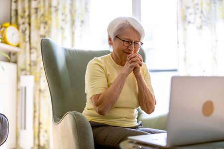 Senior woman using laptop at home