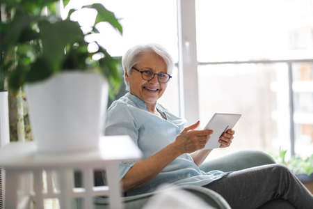 Senior woman using a digital tablet at home