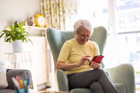 Portrait of senior woman using smartphone at home