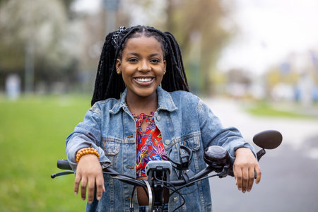 Young woman with her bike in the cityの写真素材